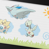 Detail van de gestikte rand en Pokémon-illustratie van de Ultra PRO Togepi Evolutions playmat